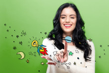 Idea Rocket With Young Woman Pointing On A Green Background