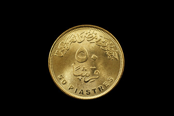 Wall Mural - A macro image of a fifty piastre coin from Egypt isolated on a black background