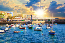 Cityscape Of Candelaria City, Harbour Illuminated By Sunset Light In Summertime In Tenerife