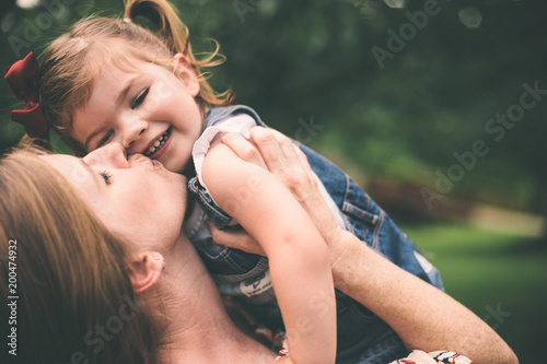 Fotografie, Obraz Mother holding daughter and showing affection