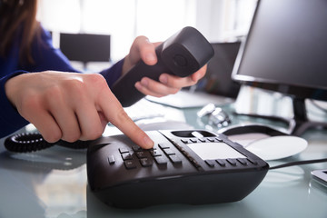 Businessperson Dialing Telephone Number To Make A Phone Call