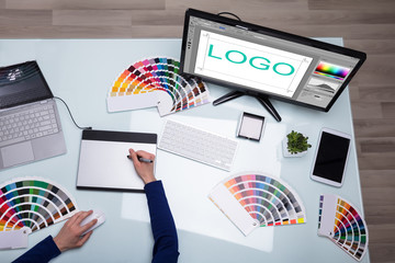 Poster - Elevated View Of Designer's Hand Working On Computer