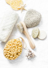 Wall Mural - shower accessories - face brush, sponge, pumice stone, towel, soap on a light background, top view. 