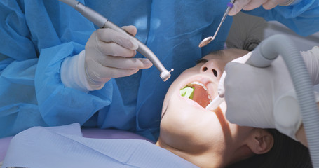 Wall Mural - Woman examining teeth at dental office