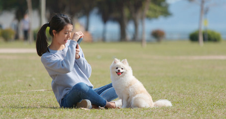 Poster - Woman taking photo with her dog