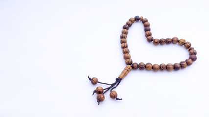 Closeup of  tasbih or rosary on a white background. Selective focus and copy space.