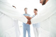 © ASDF - Doctors and nurses in a medical team stacking hands