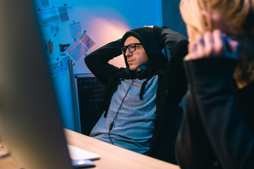 Wall Mural - female hacker looking at depressed accomplice at workplace