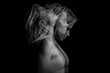 Beautiful dramatic phantom mystical mysterious ambiguous original conceptual profile side portrait of young blonde woman on a black background. Black and white photo. triple exposure.