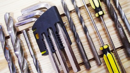 Locksmith tools on wooden background.