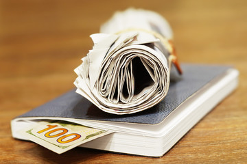 Newspapers, business notebook and one hundred dollar bill. Daily papers with fresh news, book for notes and american money in cash. Concept for savings