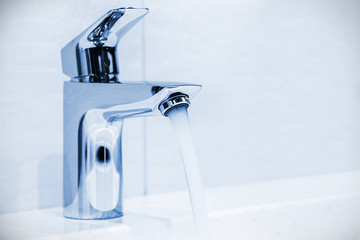 Wall Mural - water faucet in the bathroom or toilet. water flows from the tap. Toned image