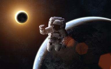 Wall Mural - astronaut. solar eclipse. moon and earth. image in 5k resolution for desktop wallpaper. elements of 