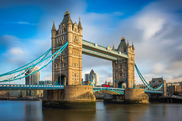 Wall Mural - London, England - Iconic Tower Bridge with traditional red double-decker bus and skyscrapers of Bank District at background