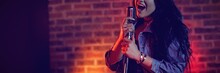 Cheerful Singer Singing Illuminated Nightclub
