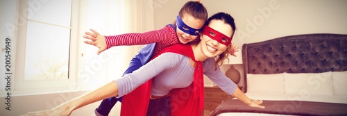 Fotografía Mother and daughter playing superwoman