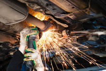 Repairer Cuts Old Silencer On Car By Angle Grinder