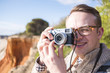 © malajscy - A photographer taking pictures of cliffs and ocean during sunny day
