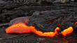 Hot magma escapes from an earth column as part of an active lava flow, the glowing lava slowly cools and freezes - Location: Hawaii, Big Island, volcano 