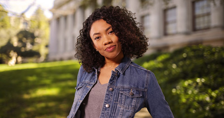 Wall Mural - Independent young African-American woman posing confidently on college campus