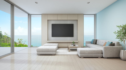 Wall Mural - Sea view living room of luxury beach house with glass door and wooden terrace. Large white sofa against blue wall near TV in vacation home or holiday villa for big family. Hotel interior 3d rendering.