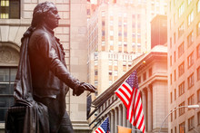 Wall Street In New York City At Sunset With The Statue Of George Washington At The Federal Hall