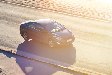 Wall Mural - Black passenger car in the sun