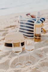 Picnic background with bag, grape and white wine by blue sea