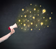 © ra2 studio - Caucasian business hand holding megaphone with yellow lightbulbs