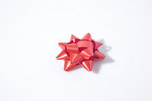 Red Flake For Gift Wrapping In A White Background