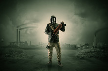 Gas Masked Survival Man Coming With Arms On His Hand  In A Demolished Dark Environment 
