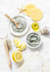 Wall Mural - homemade beauty facial mask. clay, lemon, oil, facial brush - beauty products ingredients on light b