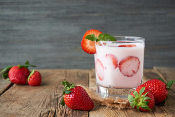 Wall Mural - Strawberry yogurt in a glass on a wooden table       