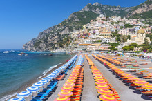 View Of Famous Rows Of Blue And Orange Beach Umbrellas On Positano Beach, Amalfi Coast, Italy.