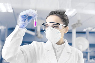 Female scientist looking at the scientific sample in the CDC laboratory