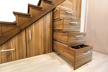 Sticker - Modern architecture interior with  luxury hallway with glossy wooden stairs in modern storey house. Custom built pullout cabinets on glides in slots under stairs