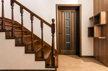 Poster - Modern brown oak wooden stairs  and doors in new renovated house interior