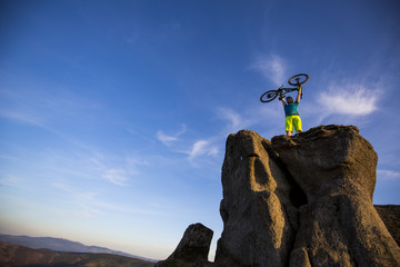 Wall Mural - Mountain biker riding on bike in summer mountains forest landscape. Man cycling MTB flow trail track. Outdoor sport activity.