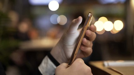 Teenage girl texting on smartphone in cafe 
