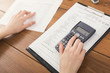 © Prostock-studio - Closeup of woman hands counting on calculator
