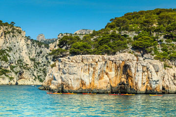 Wall Mural - Colorful kayaks in the rocky bay, Calanques national park, France