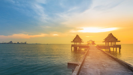 Walk way in to sea shore with sunset sky background