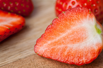 Wall Mural - Close up of red strawberry on wooden chopping board