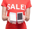 © Kabardins photo - Woman with t-shirt with an inscription sale in hand smartphone mobile phone shop buy discount
