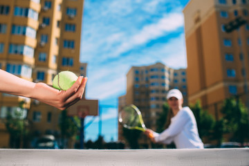 Wall Mural - female hand holding tennis ball, prepare to serve. tennis players starting set