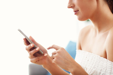 Poster - Happy woman relaxing at home with smartphone