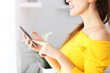 Poster - Happy woman relaxing at home with smartphone