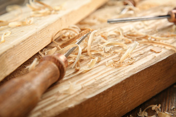 Poster - Chisel, wooden boards and sawdust in carpenter's workshop