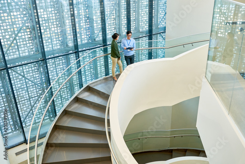 interior of spacious office building with spiral concrete staircase