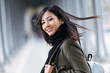 © nenetus - Pretty asian young woman smiling and looking at camera in the street.